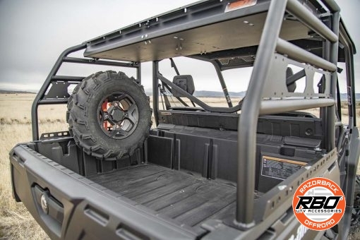 A closeup of a can am defender spare tire mount