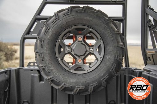 A closeup of a spare tire mounted to a can am defender spare tire mount