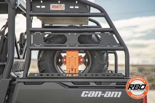 A closeup of a can am defender spare tire mount in bed of utv