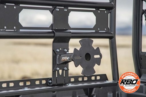 A closeup of a can am defender spare tire mount in bed of utv