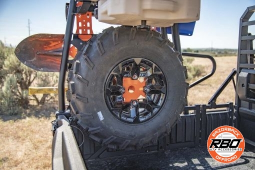 A close up of a UTV rack with Spare tire mounted