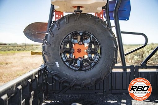 A close up of a UTV rack with Spare tire mounted