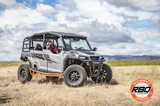 A polaris general parked on a dirt field