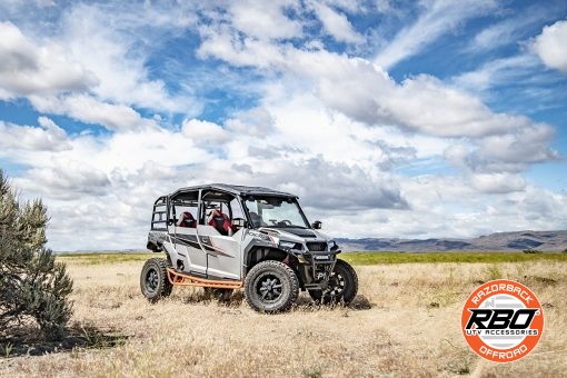 A polaris general parked on a dirt field