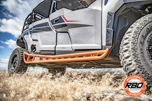 A polaris general parked on a dirt field