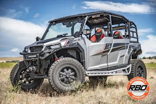 A polaris general parked on a dirt field