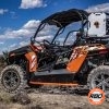 UTV parked in the dirt with a blue sky