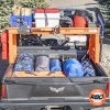 A pile of luggage in a UTV bed