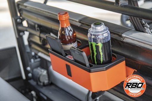 Energy drink and tea in a UTV console with cellphones