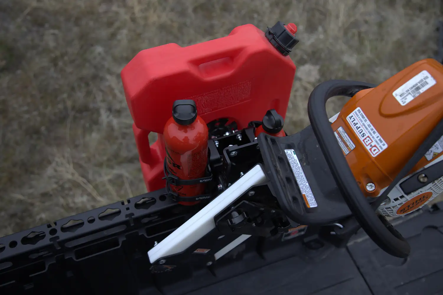 Voile Straps nylon buckle strap securing equipment and fuel can to an off-road rack mount system